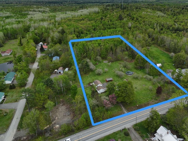 90 W Main St, Milo, ME 04463 - aerial overview of property's location featuring a forest and property parcel outlined