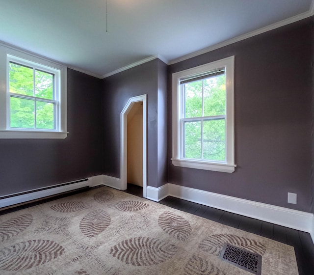 90 W Main St, Milo, ME 04463 - empty room featuring plenty of natural light, baseboards, ornamental molding, and a baseboard radiator