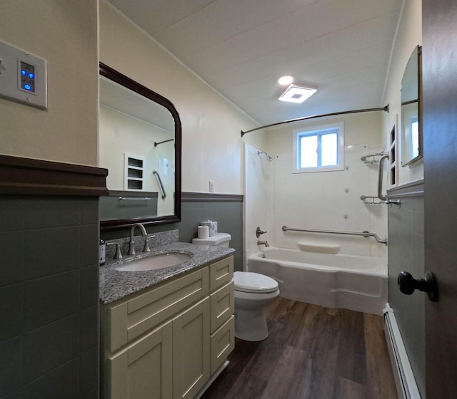 90 W Main St, Milo, ME 04463 - full bathroom featuring wood finished floors, shower / tub combination, toilet, vanity, and a baseboard heating unit