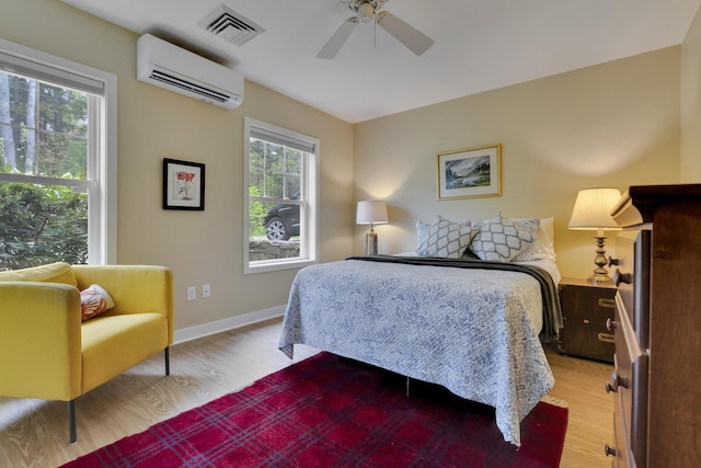 2 Round Cove Ln Unit 2, Phippsburg, ME 04562 - bedroom featuring a wall mounted air conditioner, light wood-type flooring, baseboards, and a ceiling fan