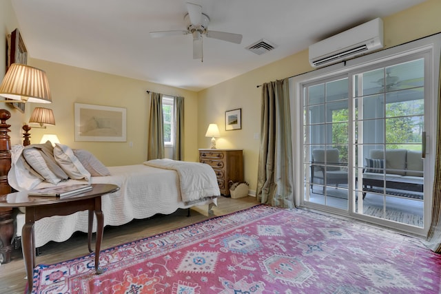 2 Round Cove Ln Unit 2, Phippsburg, ME 04562 - bedroom featuring access to exterior, a wall mounted air conditioner, wood finished floors, and ceiling fan