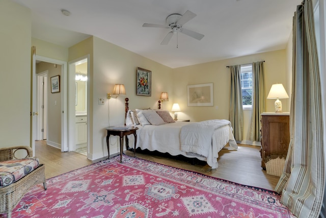 2 Round Cove Ln Unit 2, Phippsburg, ME 04562 - bedroom with light wood-type flooring, connected bathroom, baseboards, and a ceiling fan