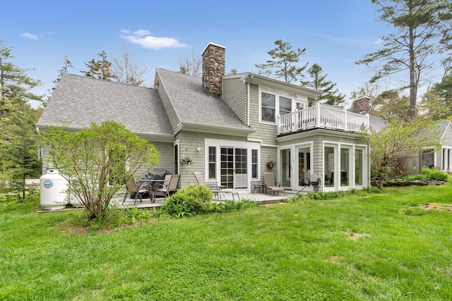 2 Round Cove Ln Unit 2, Phippsburg, ME 04562 - rear view of house with a chimney, a balcony, a patio, and a lawn