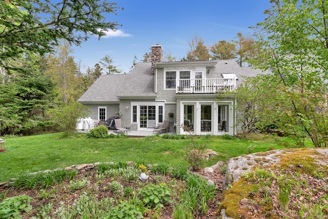 2 Round Cove Ln Unit 2, Phippsburg, ME 04562 - back of property featuring a balcony, a chimney, a patio, a lawn, and roof with shingles