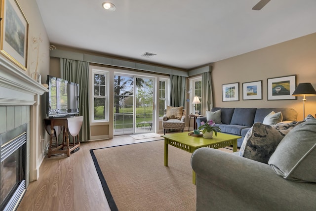 2 Round Cove Ln Unit 2, Phippsburg, ME 04562 - living room featuring a tiled fireplace and wood finished floors