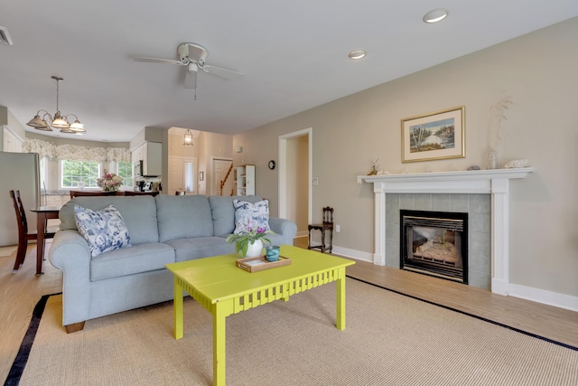 2 Round Cove Ln Unit 2, Phippsburg, ME 04562 - living room with a ceiling fan, a tiled fireplace, stairway, light wood-style floors, and recessed lighting