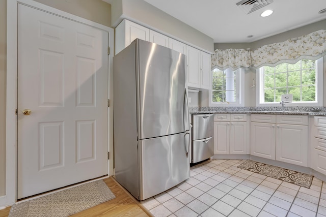 2 Round Cove Ln Unit 2, Phippsburg, ME 04562 - kitchen featuring appliances with stainless steel finishes, white cabinets, and a sink