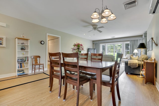 2 Round Cove Ln Unit 2, Phippsburg, ME 04562 - dining space with light wood finished floors, a chandelier, and a ceiling fan