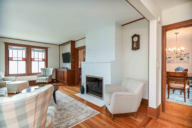 17 Bank Rd, York, ME 03909 - living room with a chandelier, light wood-style floors, and a fireplace
