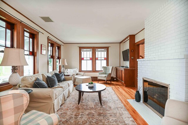 17 Bank Rd, York, ME 03909 - living area with light wood-style floors, a fireplace, and ornamental molding