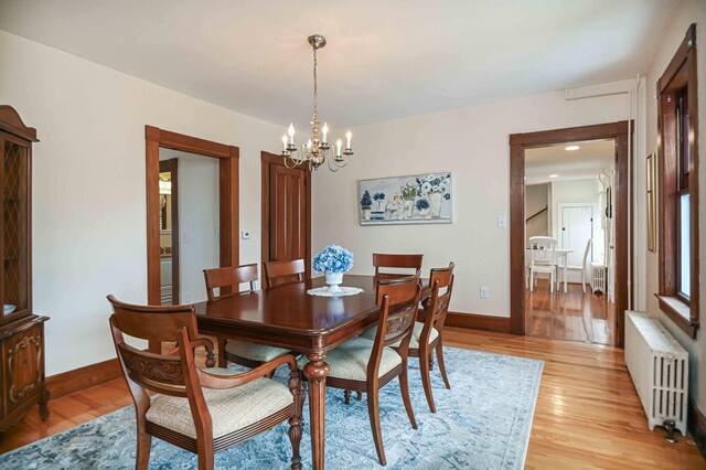 17 Bank Rd, York, ME 03909 - dining area featuring radiator, a chandelier, light wood-style floors, and baseboards