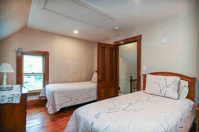 17 Bank Rd, York, ME 03909 - bedroom featuring attic access, hardwood / wood-style flooring, wallpapered walls, and vaulted ceiling