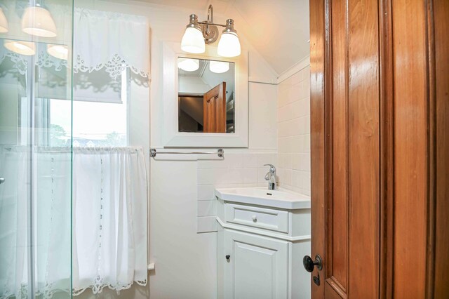 17 Bank Rd, York, ME 03909 - bathroom with vanity, tile walls, and backsplash