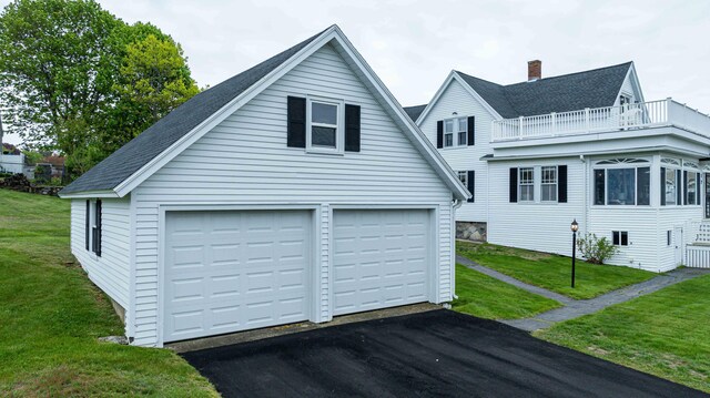 17 Bank Rd, York, ME 03909 - view of front of house featuring a balcony, an outbuilding, a shingled roof, a garage, and a front yard