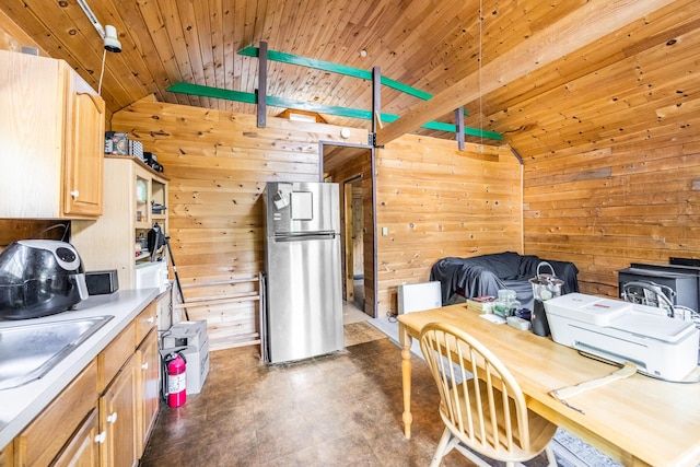 639 Main St, Springfield, ME 04487 - kitchen with freestanding refrigerator, wood walls, lofted ceiling, light brown cabinetry, and wooden ceiling