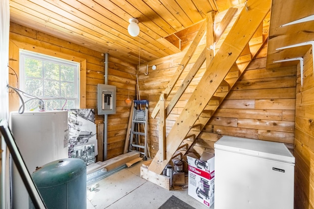 639 Main St, Springfield, ME 04487 - interior space with white fridge, electric panel, wood walls, and wooden ceiling