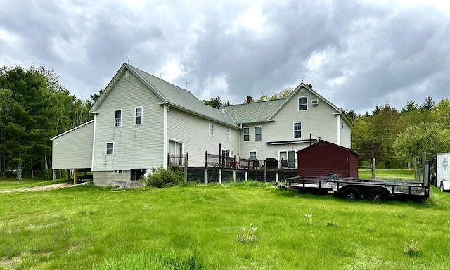 224 E Waterman Rd, Auburn, ME 04210 - back of property featuring metal roof and a yard