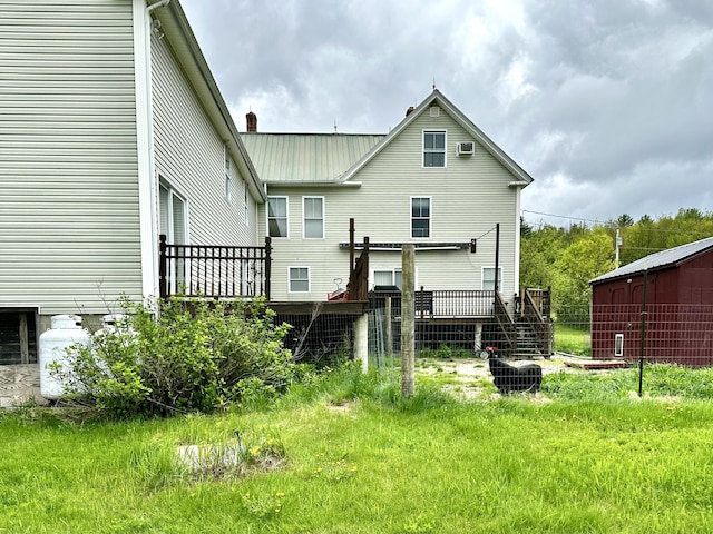 224 E Waterman Rd, Auburn, ME 04210 - rear view of house with a chimney, a deck, and metal roof
