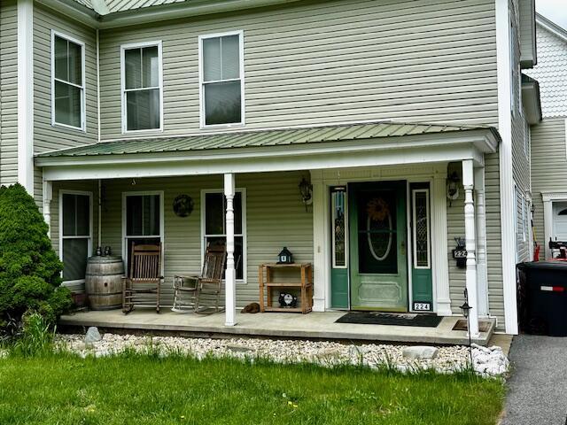 224 E Waterman Rd, Auburn, ME 04210 - view of front facade with a porch and metal roof