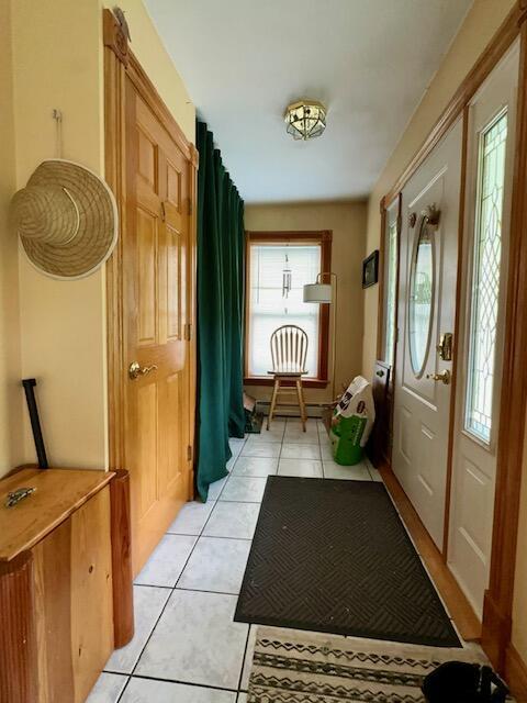 224 E Waterman Rd, Auburn, ME 04210 - doorway to outside featuring light tile patterned floors