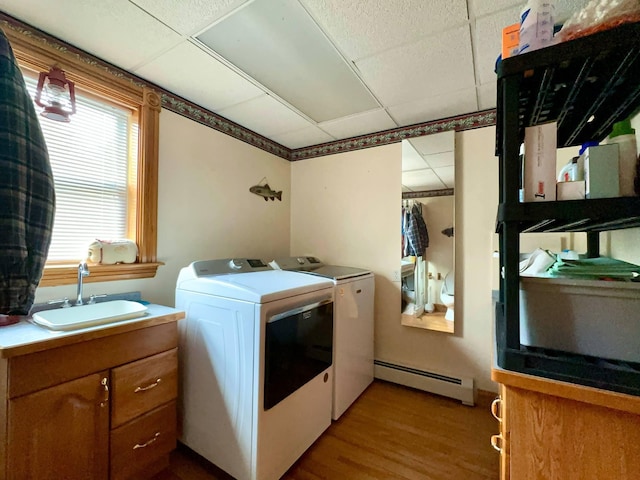 224 E Waterman Rd, Auburn, ME 04210 - laundry area featuring a baseboard radiator, washer and clothes dryer, and wood finished floors