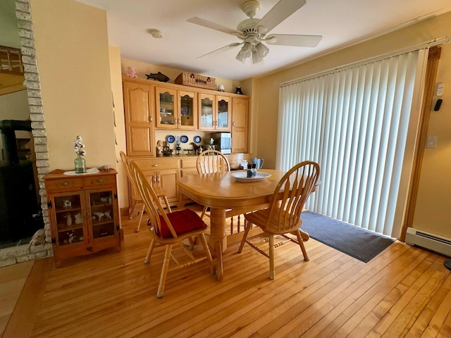 224 E Waterman Rd, Auburn, ME 04210 - dining room featuring a ceiling fan, light wood-type flooring, and a baseboard radiator