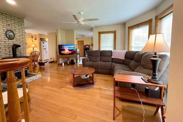 224 E Waterman Rd, Auburn, ME 04210 - living area featuring light wood-style flooring, ceiling fan, and a wood stove