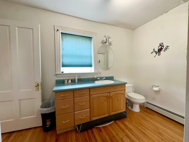 224 E Waterman Rd, Auburn, ME 04210 - bathroom with a baseboard heating unit, vanity, wood finished floors, and toilet