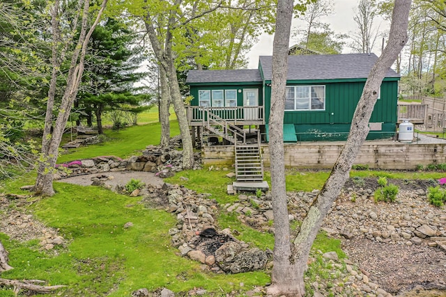 38 Cove Ln, Union, ME 04862 - view of front of house featuring board and batten siding, stairs, roof with shingles, and a front yard