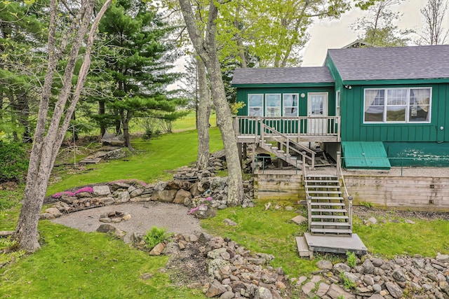 38 Cove Ln, Union, ME 04862 - view of front facade with board and batten siding, stairs, a shingled roof, and a front lawn