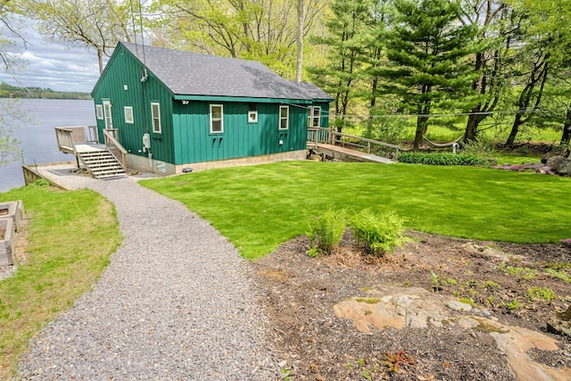 38 Cove Ln, Union, ME 04862 - view of front of house featuring board and batten siding, a shingled roof, and a front lawn