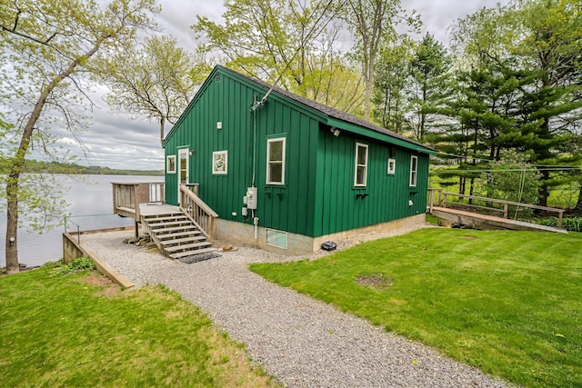 38 Cove Ln, Union, ME 04862 - view of property exterior featuring board and batten siding and a yard