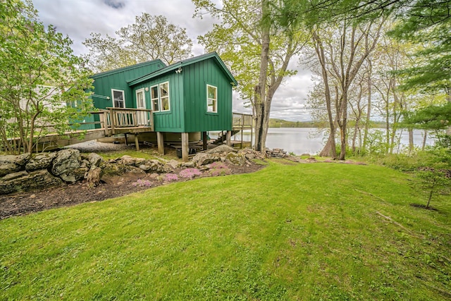 38 Cove Ln, Union, ME 04862 - rear view of house with board and batten siding, a yard, and a deck with water view