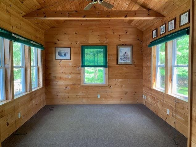 38 Cove Ln, Union, ME 04862 - carpeted empty room featuring wooden ceiling, wood walls, and a ceiling fan