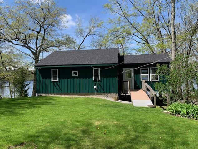 38 Cove Ln, Union, ME 04862 - view of front of property with board and batten siding and a front yard