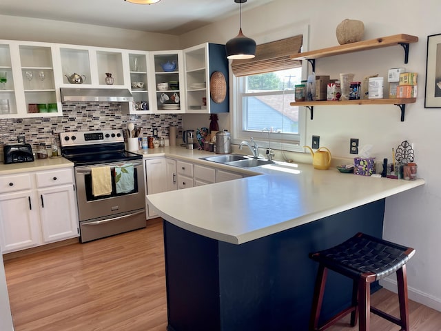 72 Winship St, Bath, ME 04530 - kitchen with open shelves, electric range, ventilation hood, a sink, and a peninsula