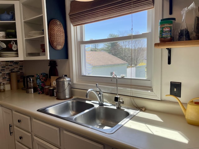 72 Winship St, Bath, ME 04530 - kitchen with a sink, white cabinetry, light countertops, and tasteful backsplash