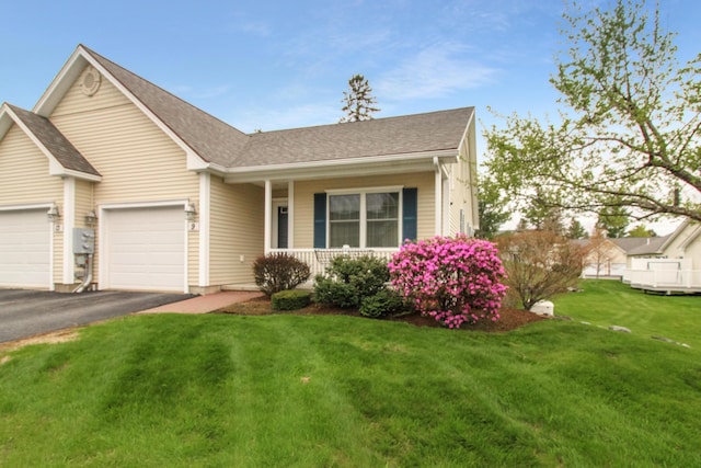 9 Camden Ct Unit 9, Bangor, ME 04401 - ranch-style house with covered porch, driveway, a front lawn, a garage, and roof with shingles