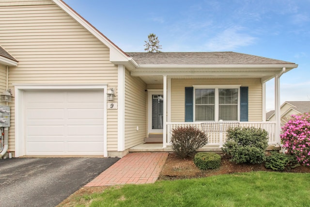 9 Camden Ct Unit 9, Bangor, ME 04401 - view of front of home featuring covered porch, driveway, a garage, and roof with shingles