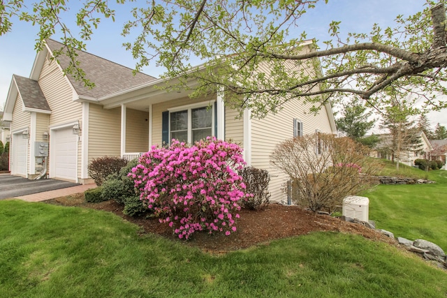 9 Camden Ct Unit 9, Bangor, ME 04401 - view of side of property featuring roof with shingles, a lawn, an attached garage, and asphalt driveway