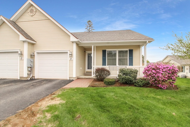 9 Camden Ct Unit 9, Bangor, ME 04401 - view of front facade with covered porch, driveway, a front lawn, a garage, and a shingled roof
