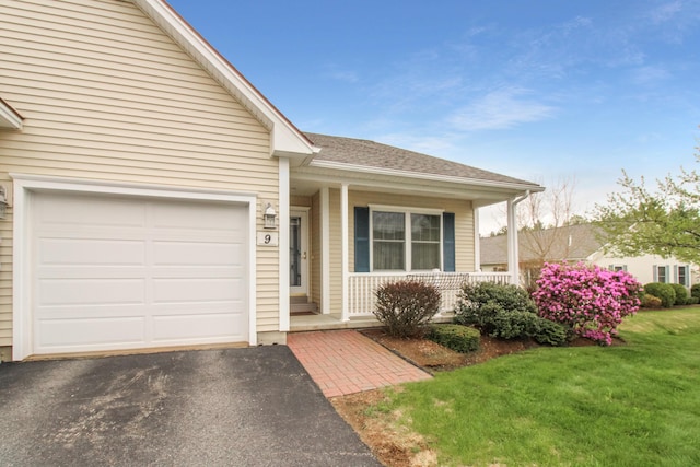 9 Camden Ct Unit 9, Bangor, ME 04401 - single story home with covered porch, an attached garage, driveway, a front lawn, and a shingled roof