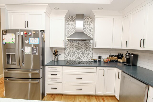 9 Camden Ct Unit 9, Bangor, ME 04401 - kitchen with stainless steel appliances, wall chimney range hood, dark countertops, and light wood finished floors