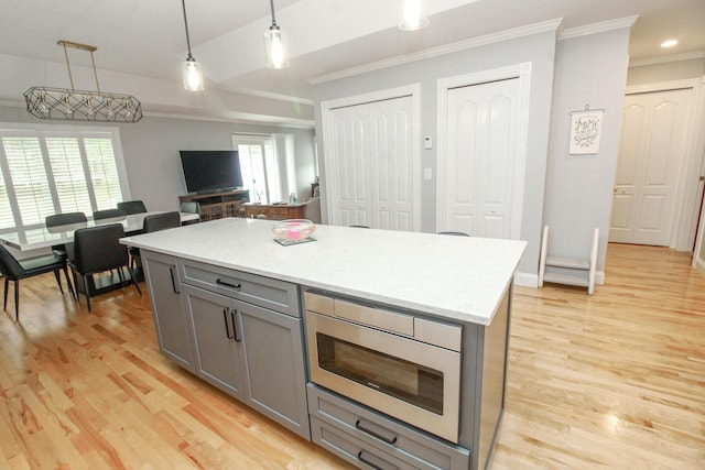 9 Camden Ct Unit 9, Bangor, ME 04401 - kitchen featuring gray cabinets, crown molding, hanging light fixtures, light wood-type flooring, and oven