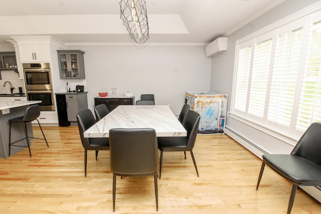 9 Camden Ct Unit 9, Bangor, ME 04401 - dining room with a wall unit AC, baseboard heating, light wood-type flooring, healthy amount of natural light, and crown molding