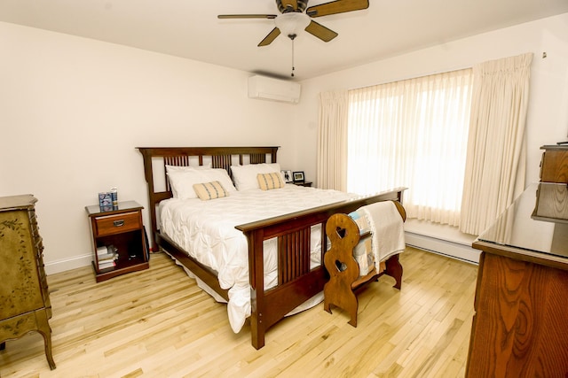 9 Camden Ct Unit 9, Bangor, ME 04401 - bedroom featuring a baseboard heating unit, an AC wall unit, light wood finished floors, a ceiling fan, and baseboards