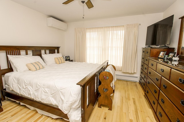 9 Camden Ct Unit 9, Bangor, ME 04401 - bedroom with a baseboard heating unit, a wall unit AC, light wood-style floors, and a ceiling fan