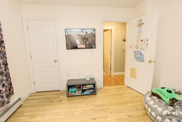 9 Camden Ct Unit 9, Bangor, ME 04401 - hallway with baseboard heating, wood finished floors, and baseboards