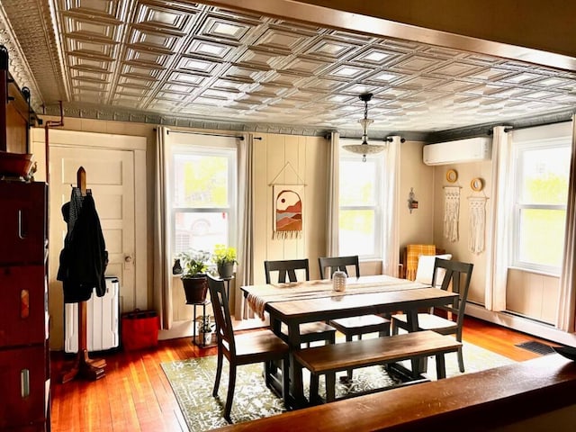 90 N Ave, Skowhegan, ME 04976 - dining space featuring an ornate ceiling, a wall mounted AC, and hardwood / wood-style flooring