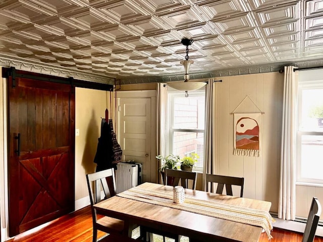 90 N Ave, Skowhegan, ME 04976 - dining room with a barn door, an ornate ceiling, wood finished floors, a baseboard radiator, and radiator